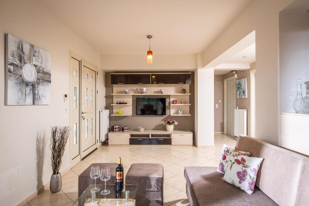 a living room with a couch and a table at Sunshine Koutouloufari in Hersonissos