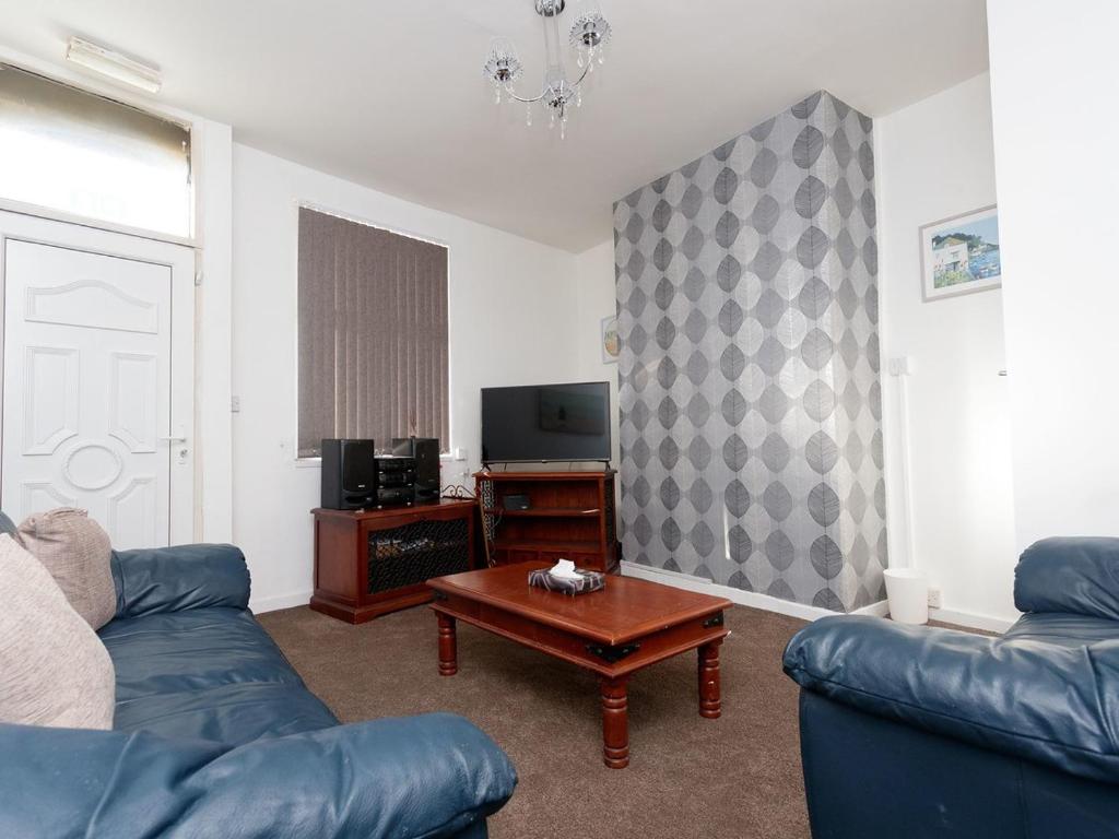 a living room with a couch and a coffee table at Eastpark Residence in Leeds