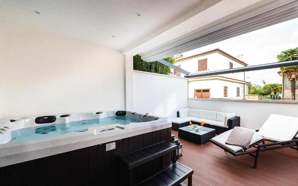 a large jacuzzi tub in a room with a patio at Apartment Auretta in Novigrad Istria