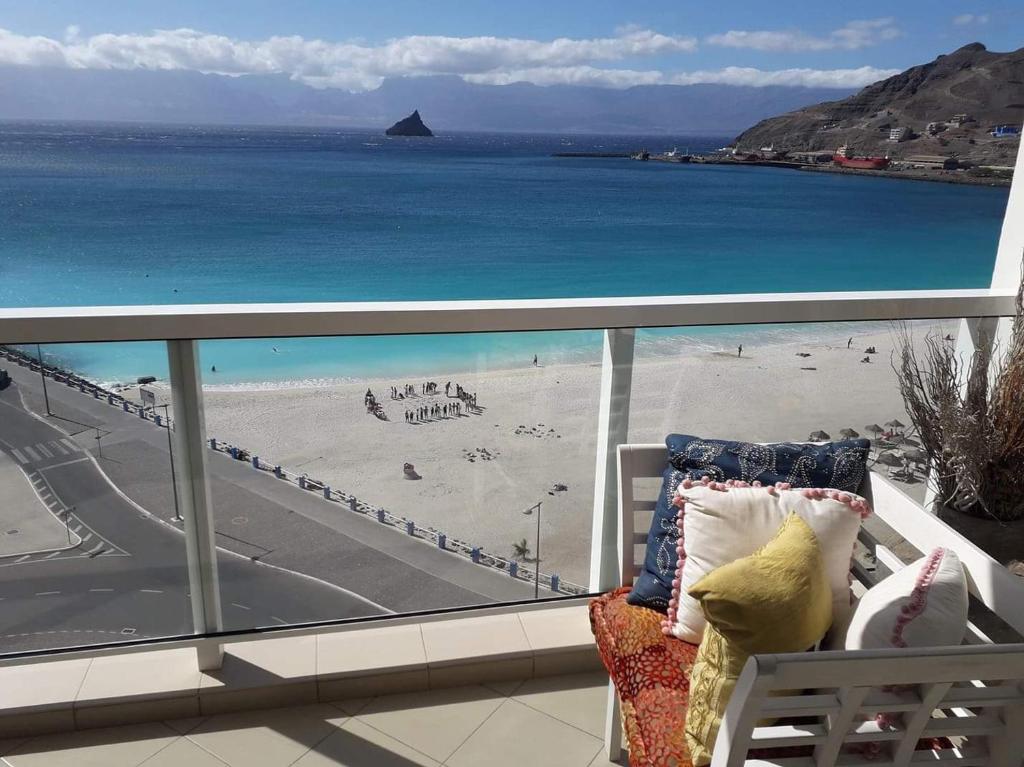 a balcony with a view of a beach and the ocean at @Georgette in Mindelo