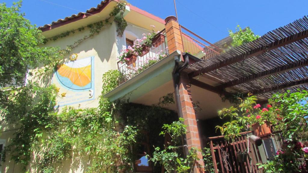 a house with a balcony with flowers on it at Nonna Lelletta in Lanusei