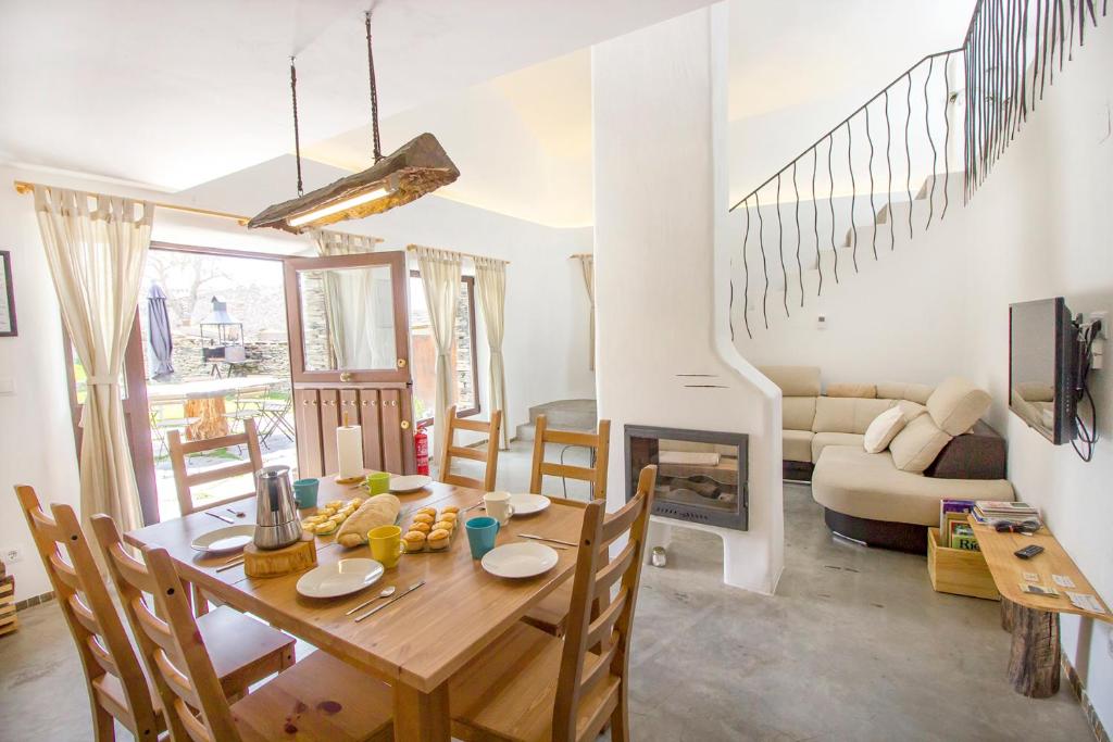 a dining room with a table and a fireplace at El Pajar Negro in Majaelrayo