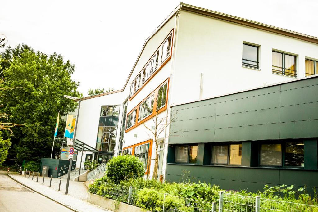 a building on the side of a street at HI Munich Park Youth Hostel in Munich