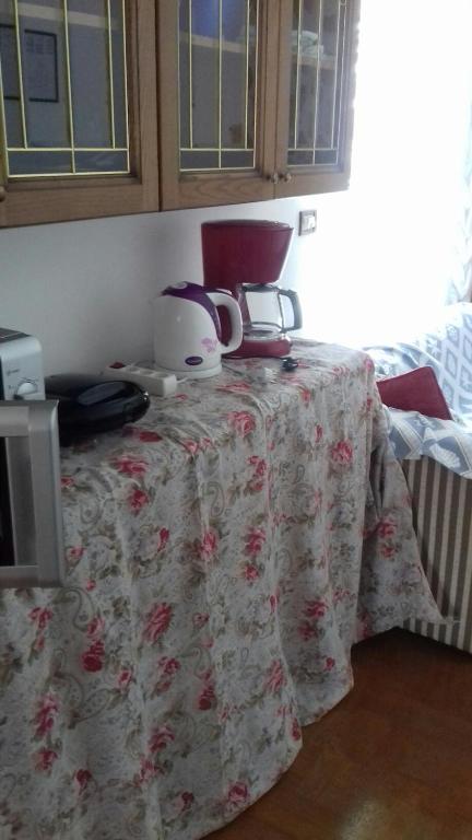 a table with a flowered table cloth on it at Villa Verde Apartments and Rooms in Premantura