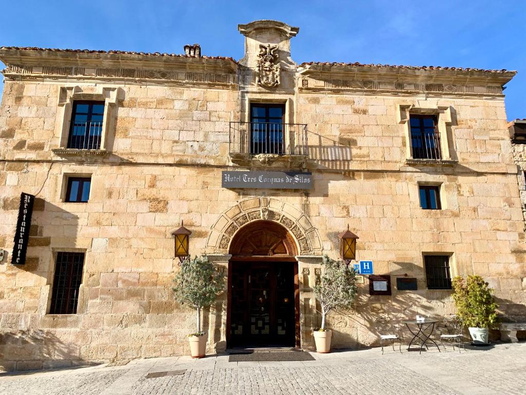 a stone building with a door in front of it at Hotel Tres Coronas de Silos in Santo Domingo de Silos
