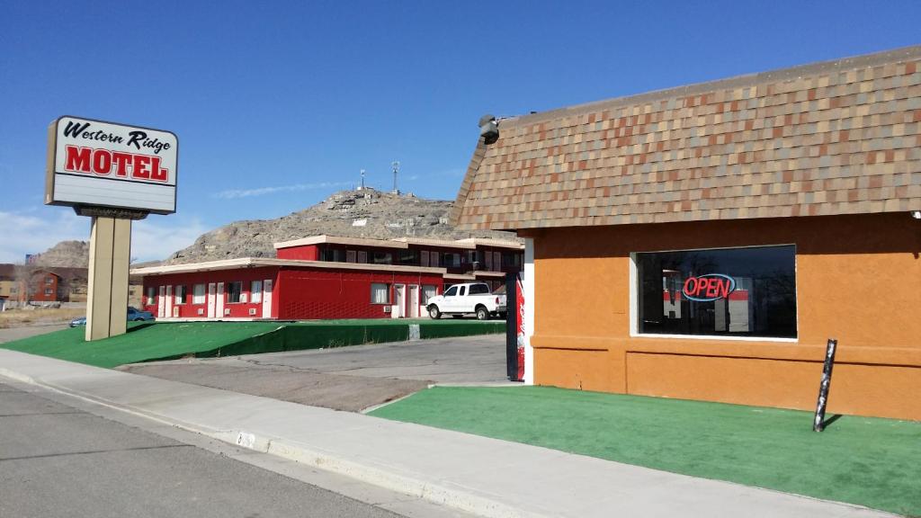 a motel with a sign on the side of a building at Western Ridge Motel in Wendover