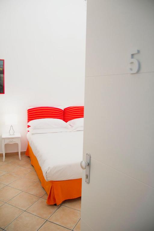 a bedroom with a bed with an orange and white at Casa Sorrentina in Sorrento