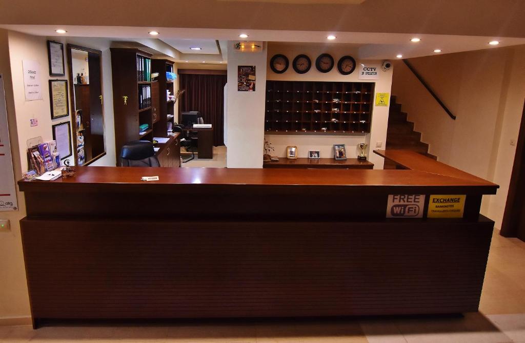 a bar in a wine shop with a staircase at 24 Seven Boutique Hotel in Malia
