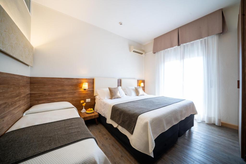 Postel nebo postele na pokoji v ubytování B City Hotel