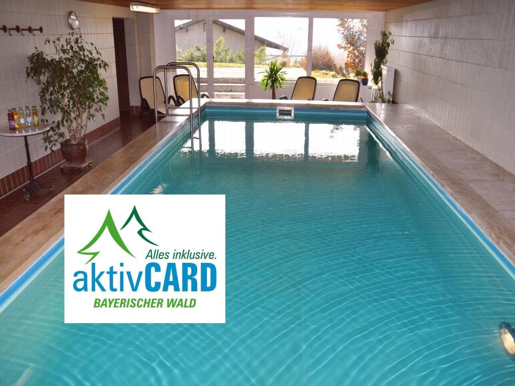 a swimming pool with a sign that reads alpha cardkeeper wall at Landhaus Harmonie in Arnbruck
