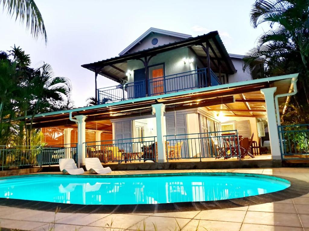 a house with a swimming pool in front of a house at VILLA DES ILES MONT CHOISY in Mont Choisy