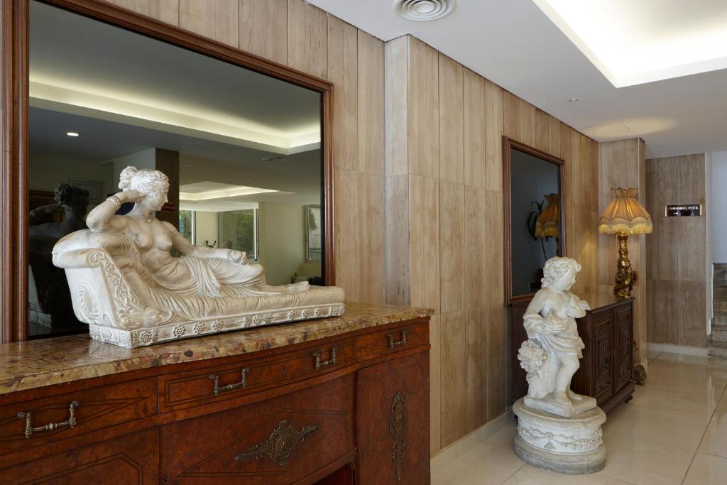 a statue on a dresser in a room with a mirror at Zoukotel Hotel in Jounieh