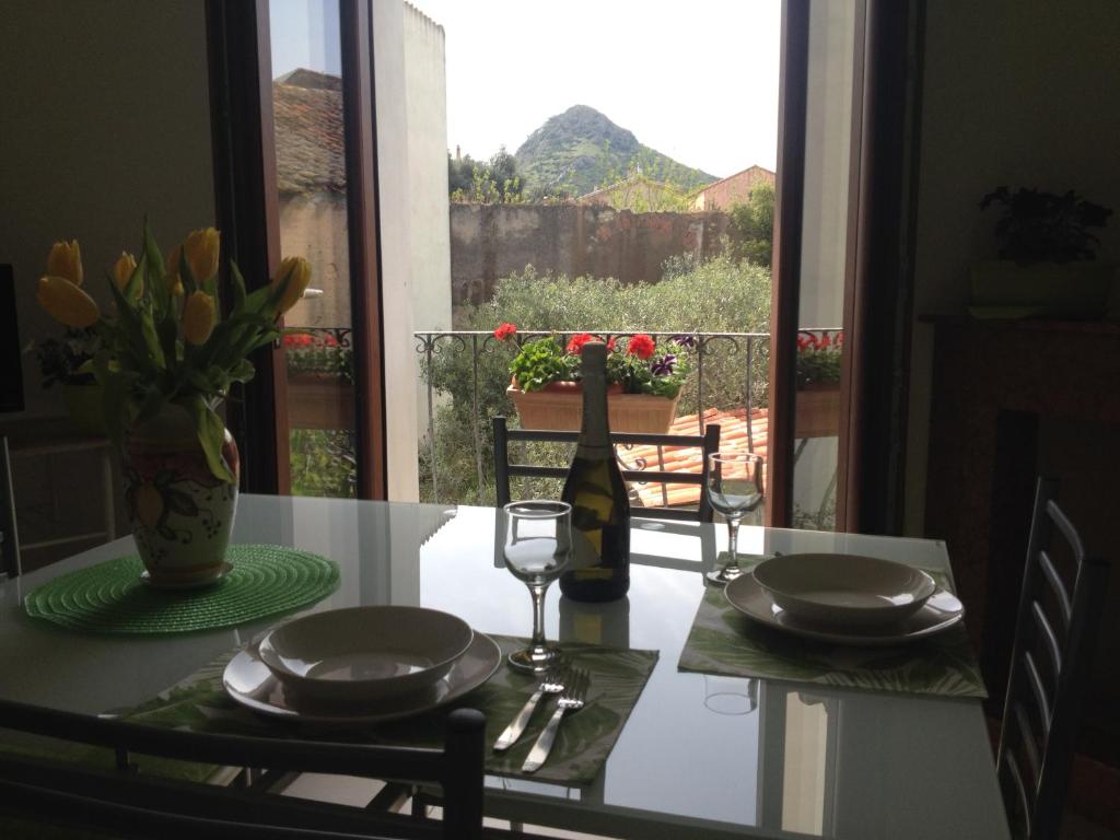 una mesa con una botella de vino y dos copas en Ampio appartamento Sulcis Iglesiente Sardegna, en Gonnesa