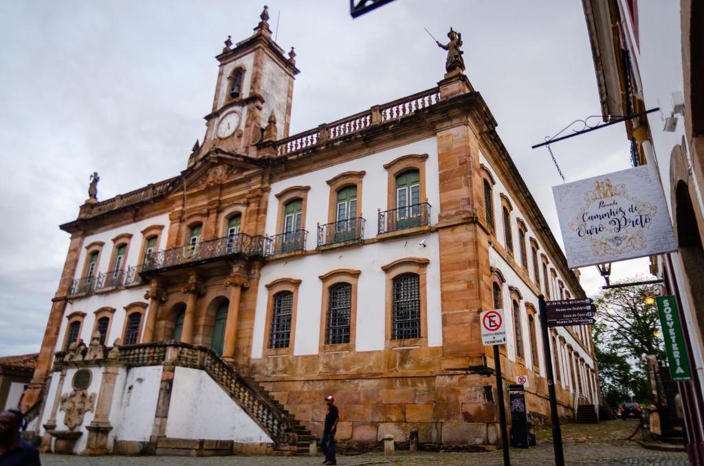 a building with a clock tower on top of it at Caminhos De Ouro Preto in Ouro Preto
