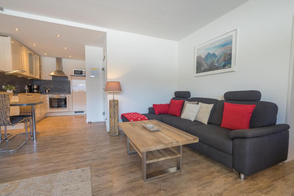 a living room with a couch and a table at Ferienwohnungen Alpentraum - Wiesenblume in Oberstdorf