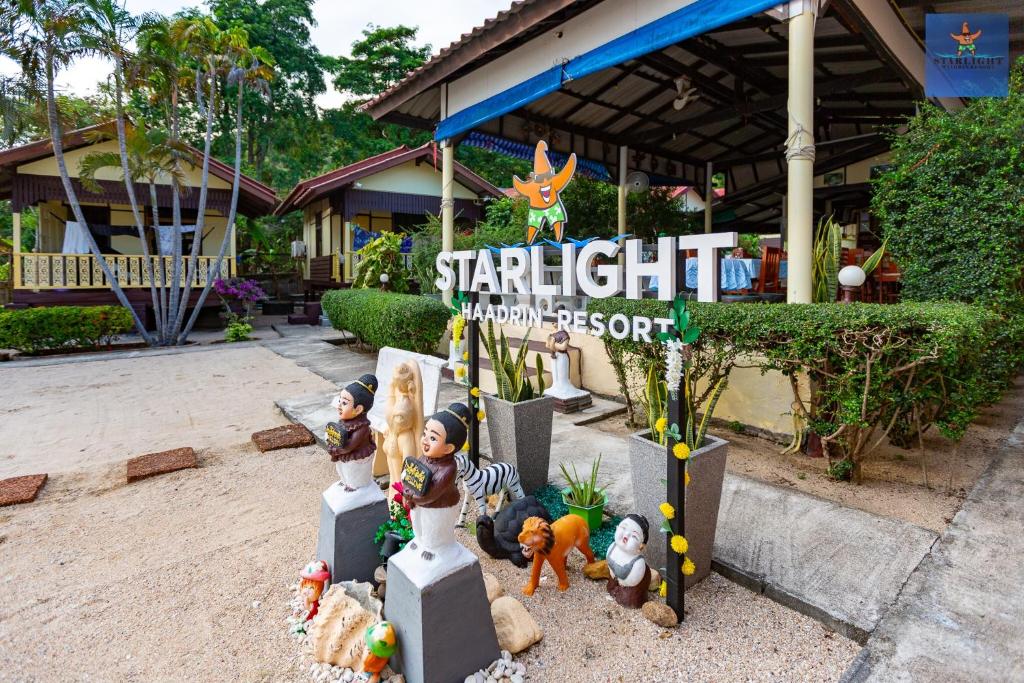 a group of toy figurines in front of a restaurant at Starlight Haadrin Resort in Haad Rin