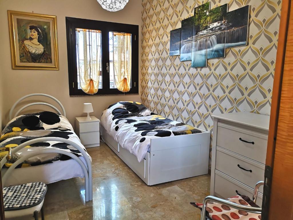 a small bedroom with a bed and a dresser at Casa Vacanze Volpe Dell'Etna in Nicolosi