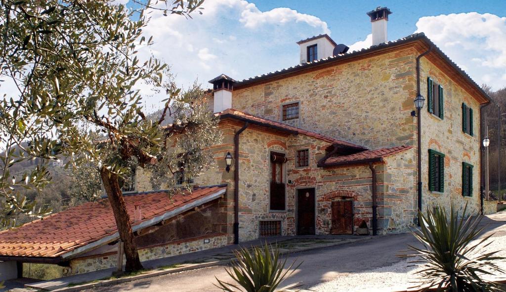 a large building with a large window and some trees at Agriturismo Il Calesse in Quarrata