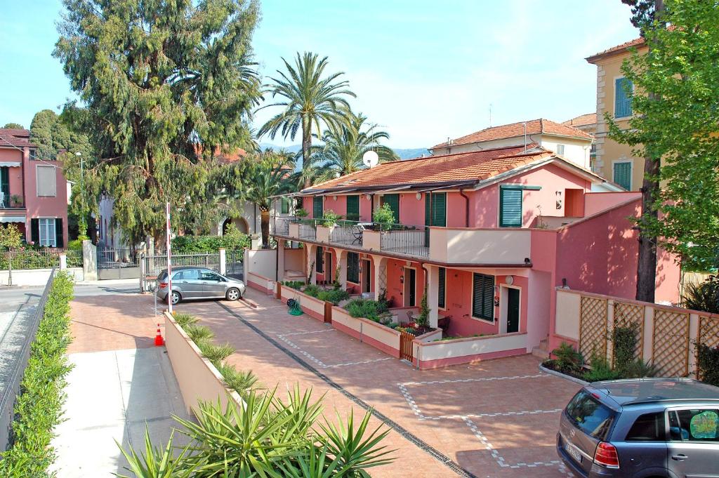 a house with a car parked in front of it at World Village Apartments in Diano Marina