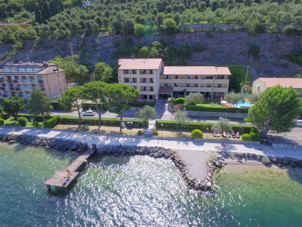 an aerial view of a resort in the water at Residence Lido Hotel in Malcesine