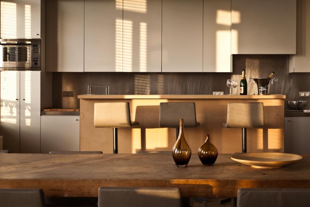 two vases sitting on a wooden table in a kitchen at Loft O - River View in Antwerp