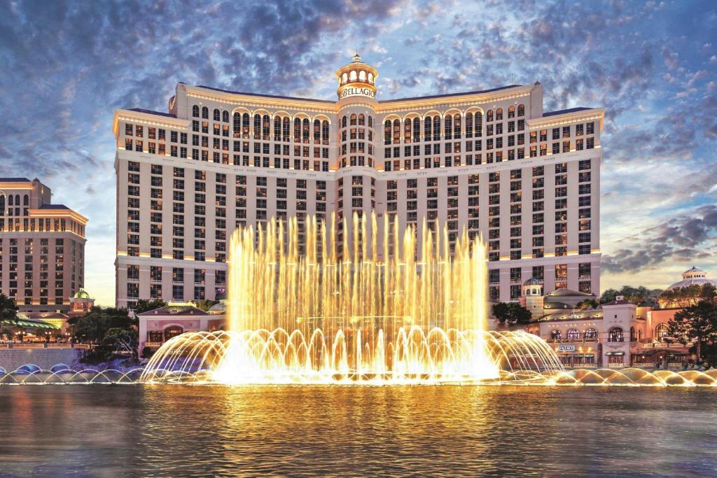 a fountain in the water in front of a large building at Bellagio in Las Vegas