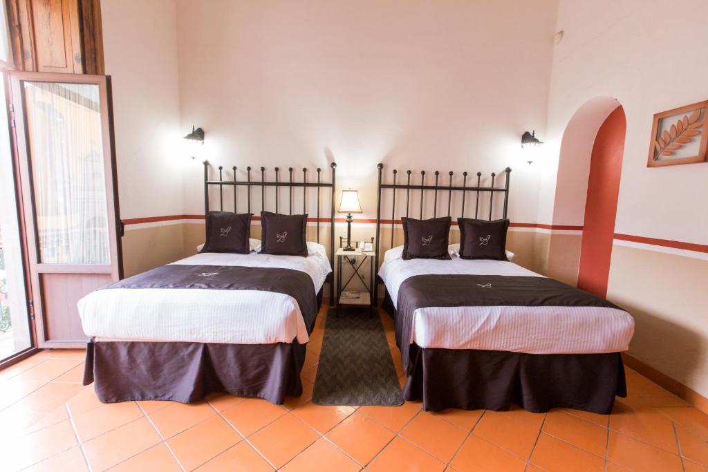 Postel nebo postele na pokoji v ubytování Hotel de la Paz