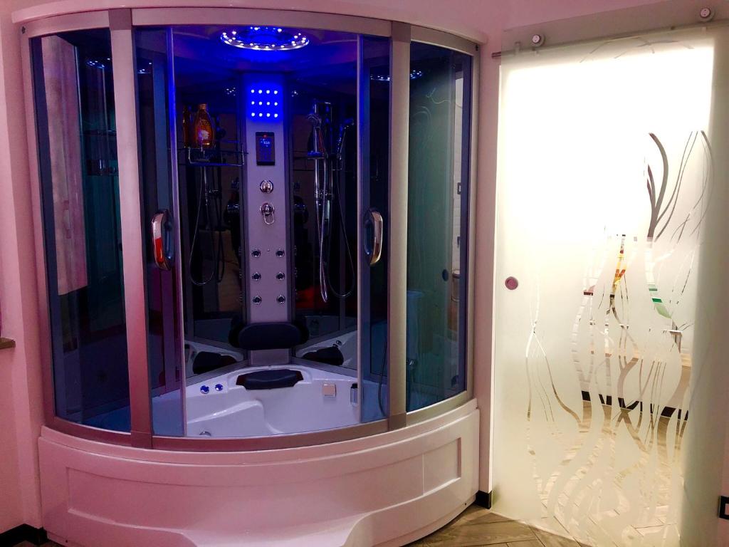 a shower in a room with blue lights at B&B WELLNESS Junior Suite CAREN in Grinzane Cavour