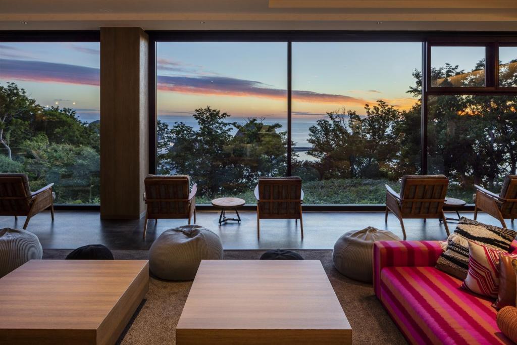 a living room with a view of the ocean at Shiretoko Yuhi No Ataruie Onsen Hostel in Shari