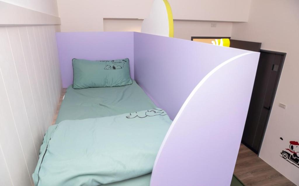 A bed or beds in a room at Wujie Childlike B&B