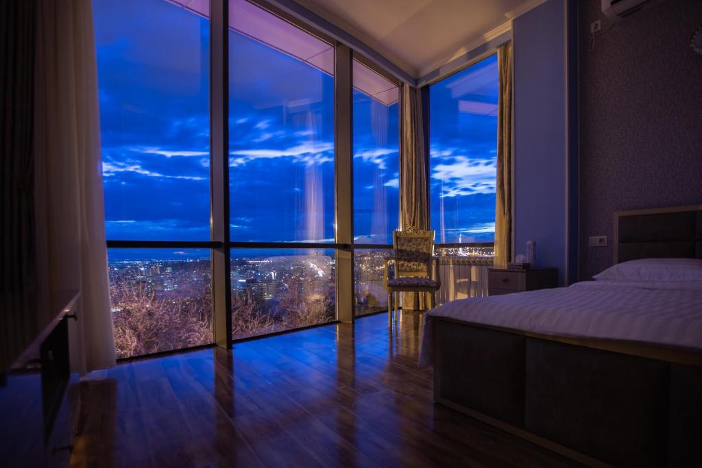 a bedroom with a large window with a city view at Nork Hotel in Yerevan