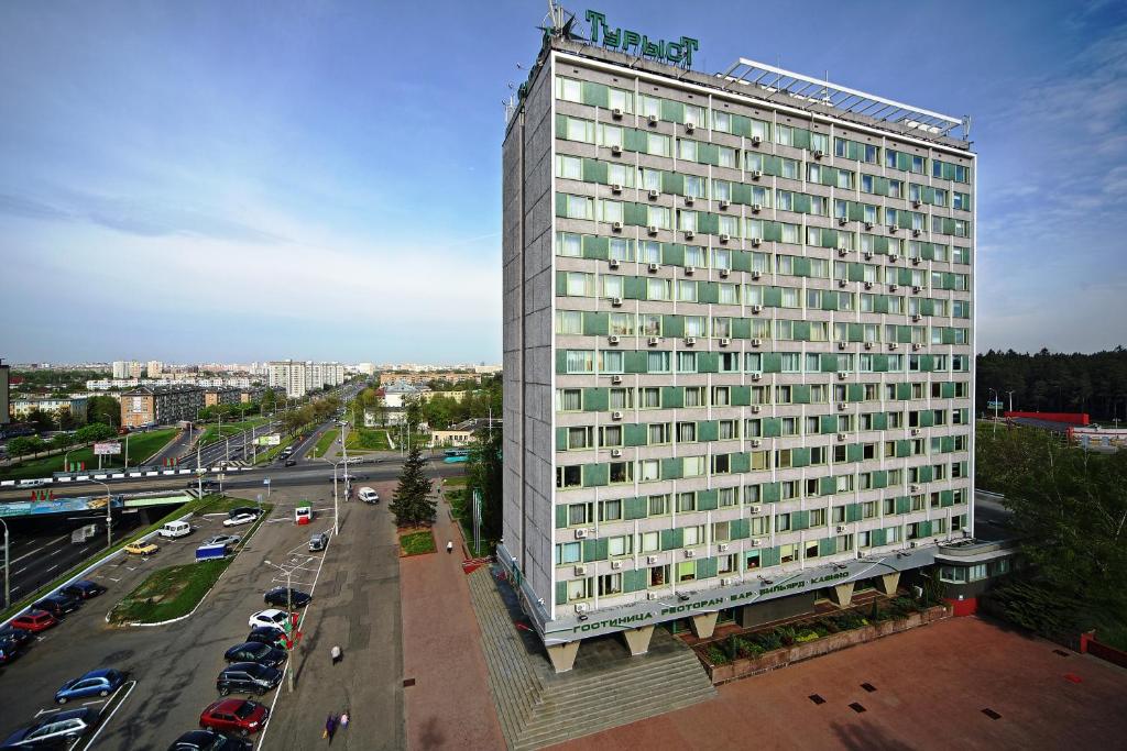 
a large white building with a lot of windows at Tourist Hotel in Minsk
