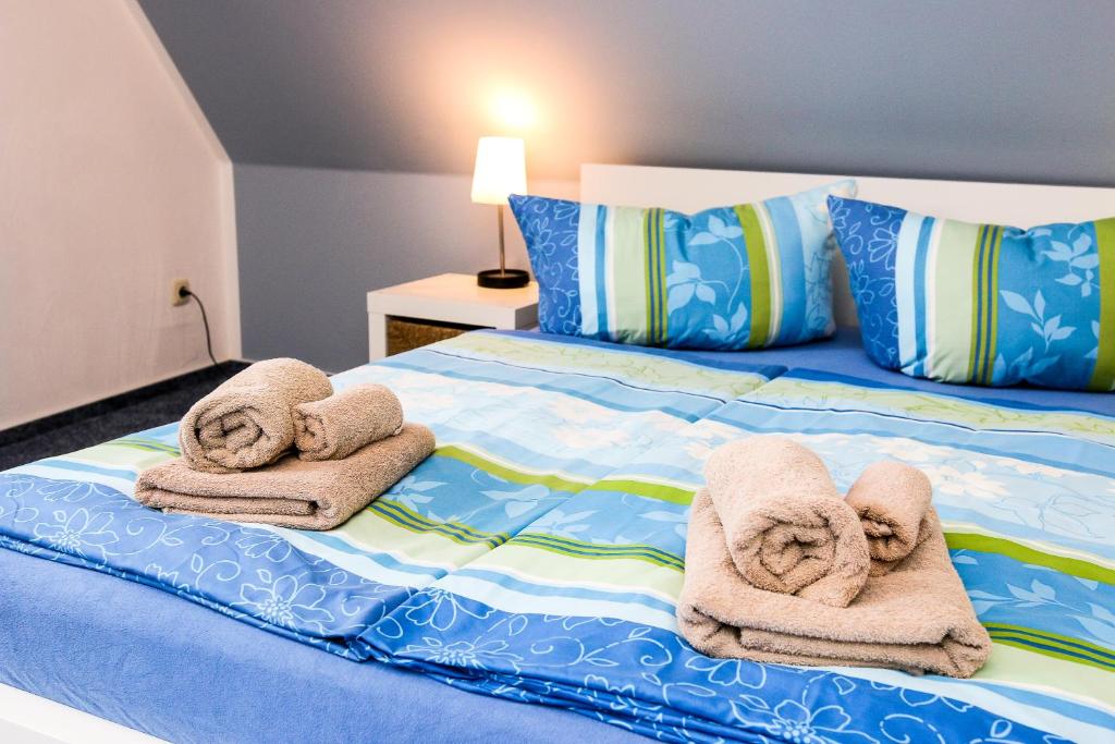 a bed with towels and pillows on it at Apartment in der Alexandrinenstrasse in Warnemünde