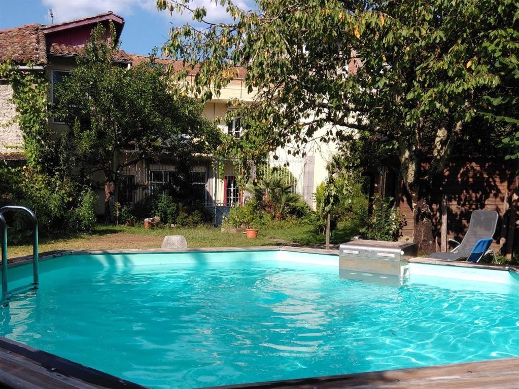 a swimming pool in the backyard of a house at Le Patio Gironnais in Saint-Girons