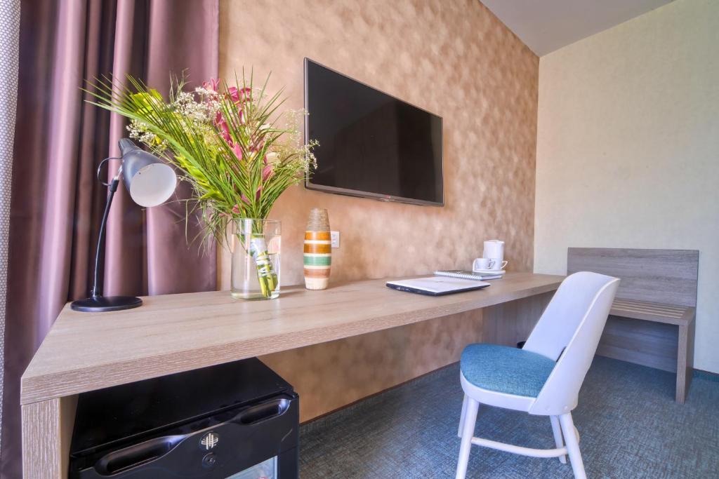 TV a/nebo společenská místnost v ubytování Garni Hotel Mint