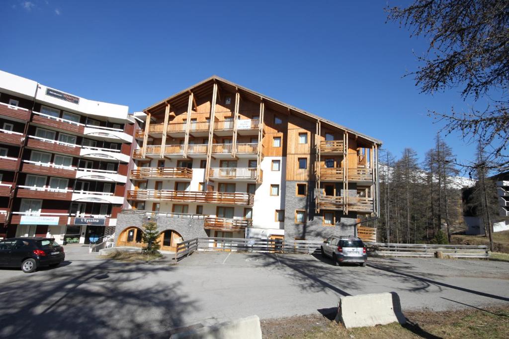 an apartment building under construction in a parking lot at L&#39;Ecrin des Neiges in Vars