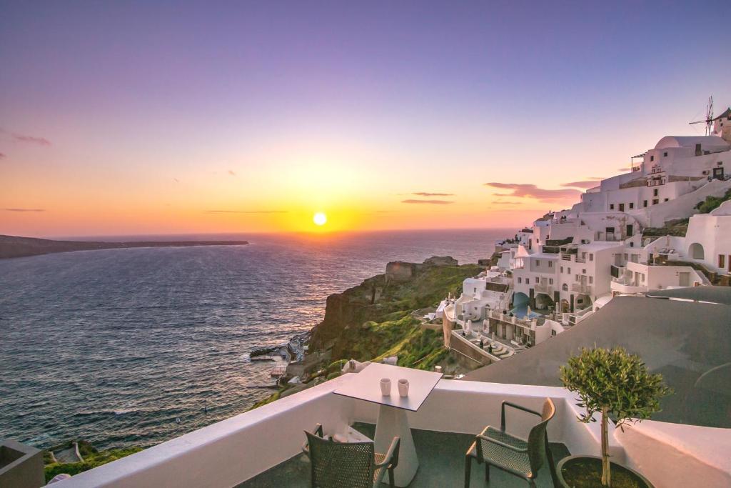 a view from a balcony overlooking the ocean at Theodora Suites in Oia