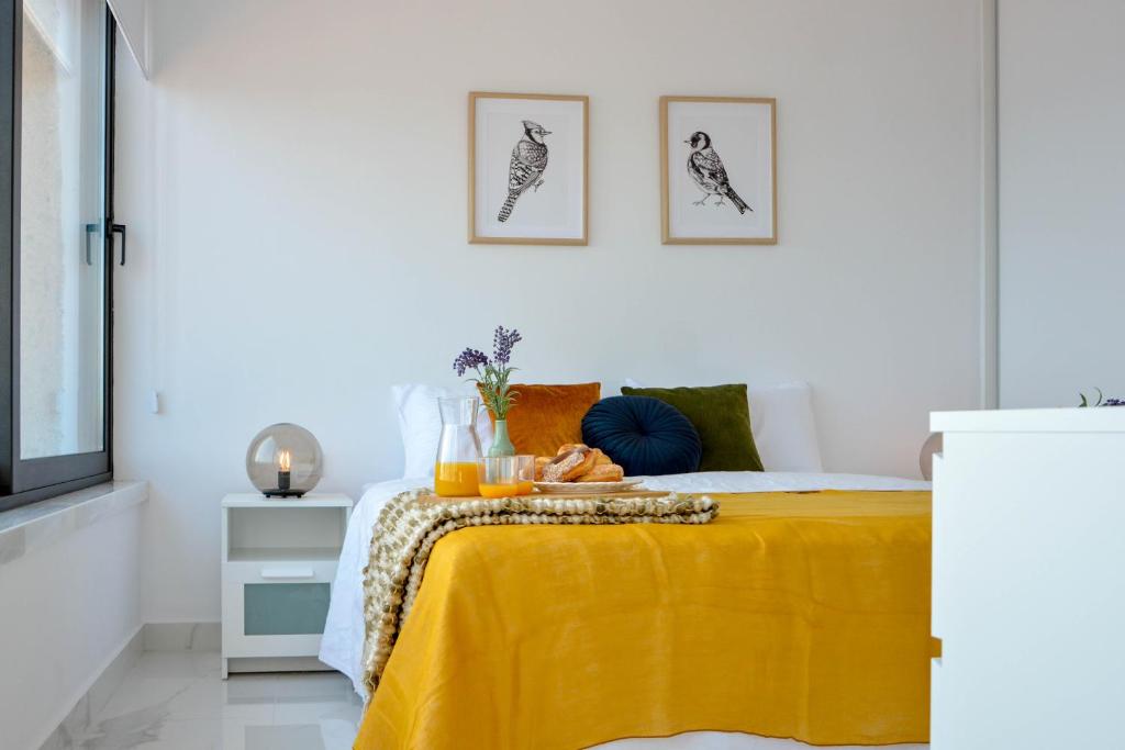 a bedroom with a bed with a yellow blanket at Phaedrus Living Seaview Luxury Flat Marina Court 213 in Paphos