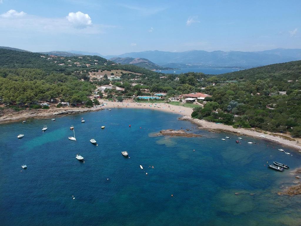 an aerial view of a beach with boats in the water at Village Naturiste La Chiappa in Porto-Vecchio