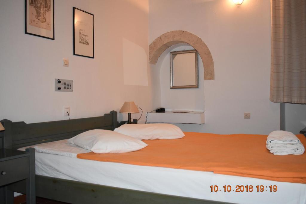 Postel nebo postele na pokoji v ubytování Vecchio Hotel