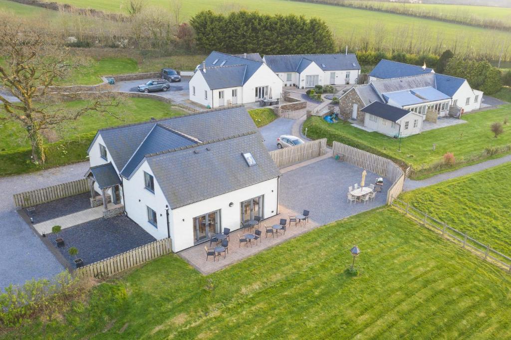 an aerial view of a large white house at Canaston Oaks in Narberth