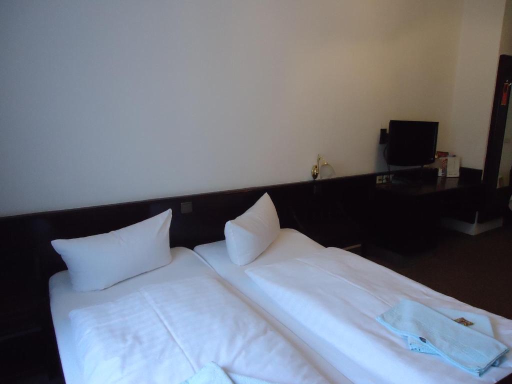 Postel nebo postele na pokoji v ubytování Hotel Marthahaus