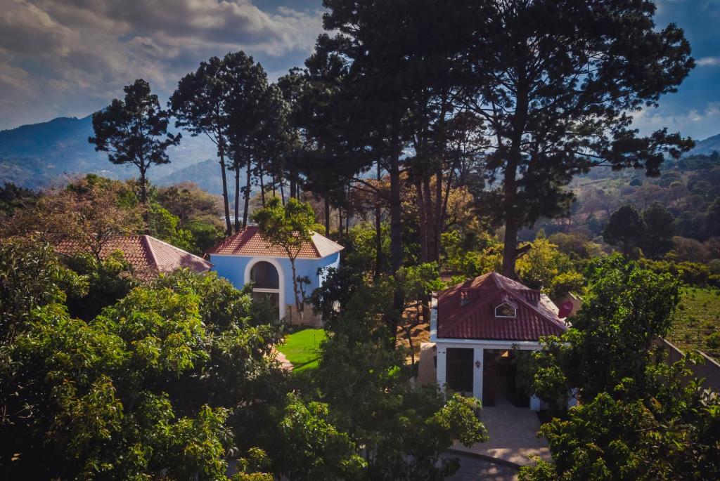 una vista aérea de una casa blanca con árboles en HOTEL Y RESTAURANTE HACIENDA LOS VOLCANES, en Santa Lucía Milpas Altas