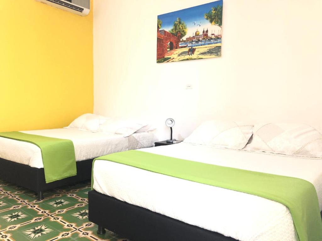 Postel nebo postele na pokoji v ubytování Hotel Balcones de Bocagrande