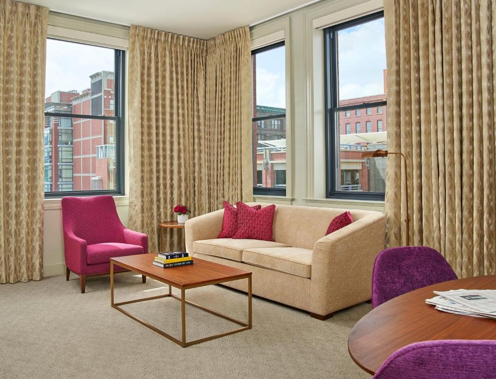 a living room filled with furniture and a window at 21c Museum Hotel Kansas City in Kansas City