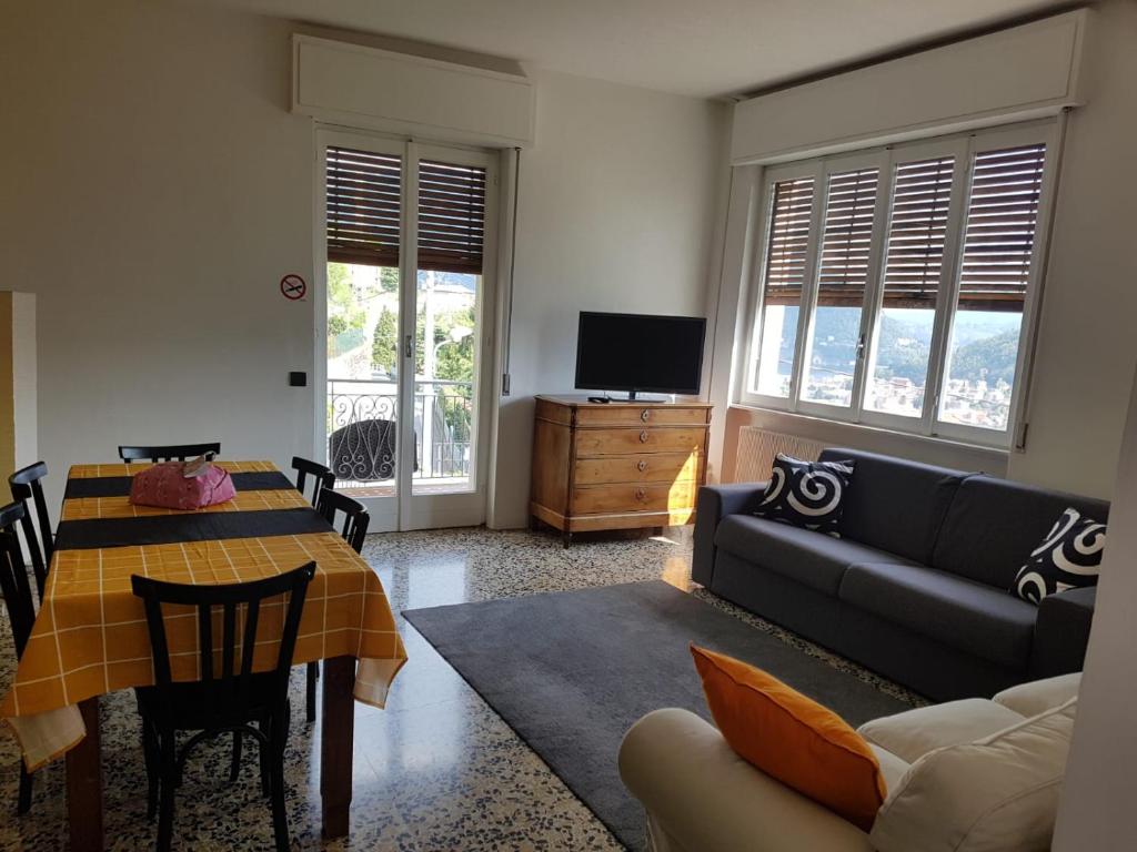 a living room with a table and a couch at ComoVà in Maslianico