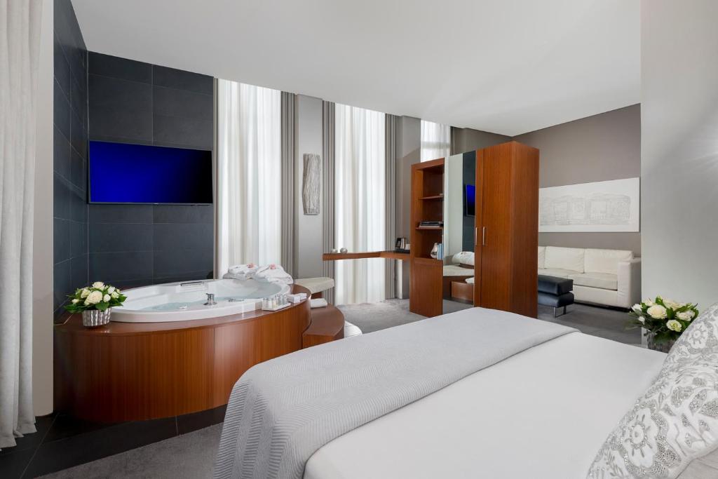 Postel nebo postele na pokoji v ubytování Metropolis - Hotel di Charme