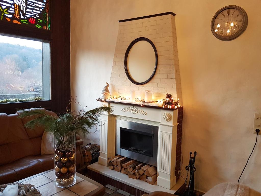 a living room with a fireplace and a mirror at Hotel Restaurant Klostermühle in Reutlingen