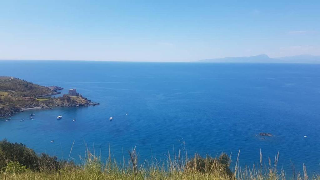 a large blue body of water with boats in it at Hotel Villa Principe in San Nicola Arcella
