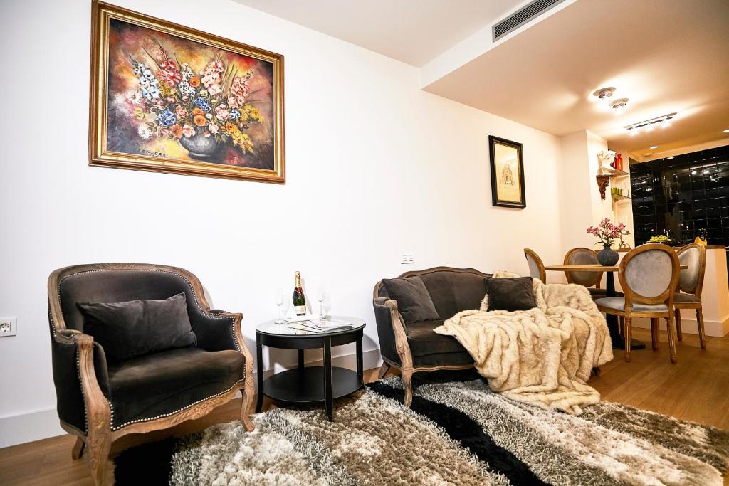 a living room with two chairs and a table at Lux Apartments Barcelona in Barcelona